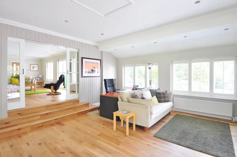 Living room with glazed internal doors, white skirting boards and an oak floor